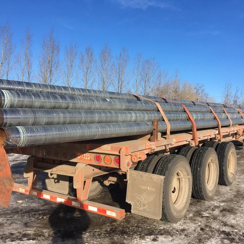 Image of metal pipes stacked on a flatbed truck