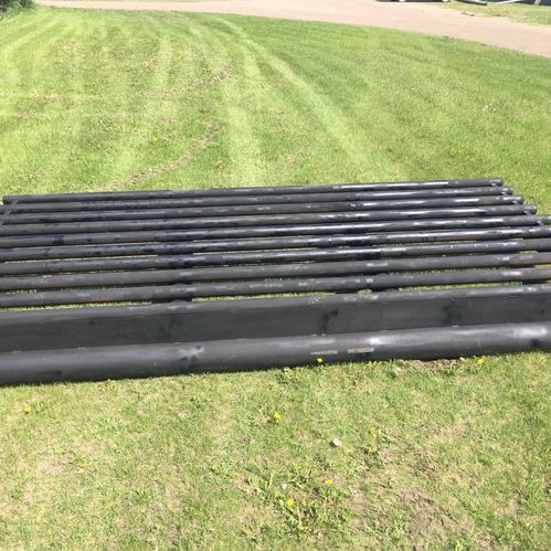 View of metal cattle guard laying on a grass field